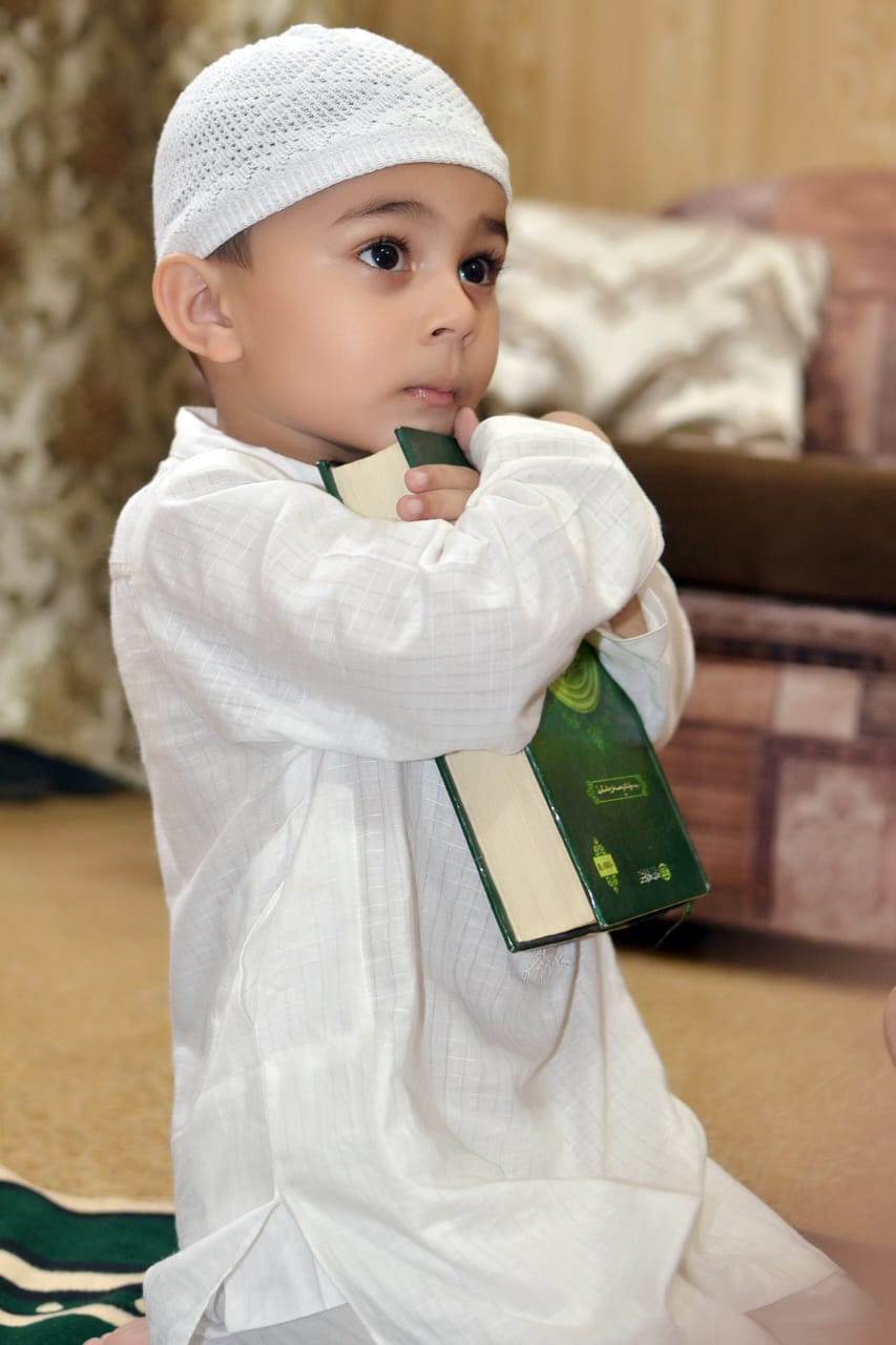 Young child holding a Quran